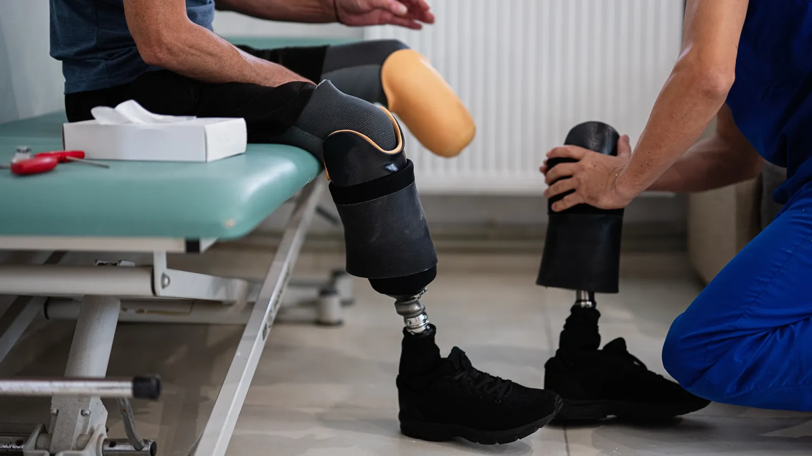nurse fitting prosthetic leg