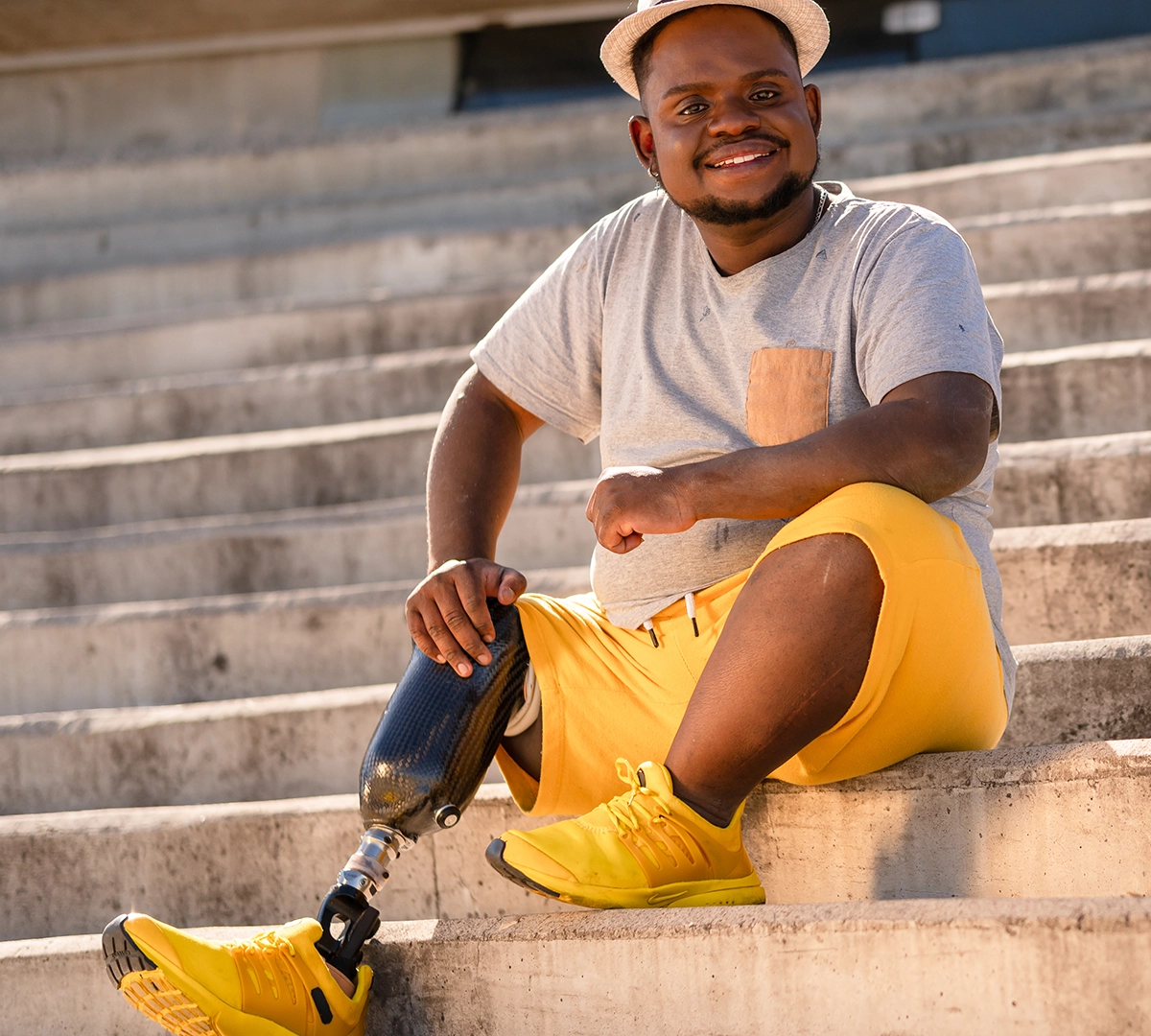 man sitting on step with prosthetic leg